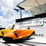 Yellow and orange jet skis beside yacht 'Princess Hope'