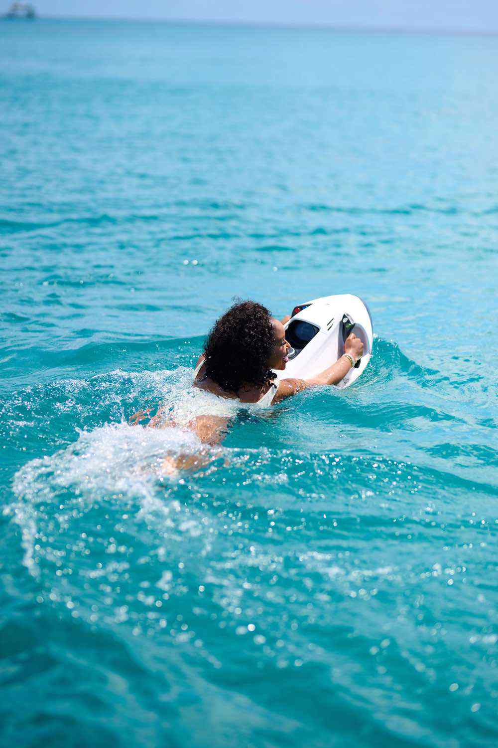 Person snorkeling in clear blue ocean