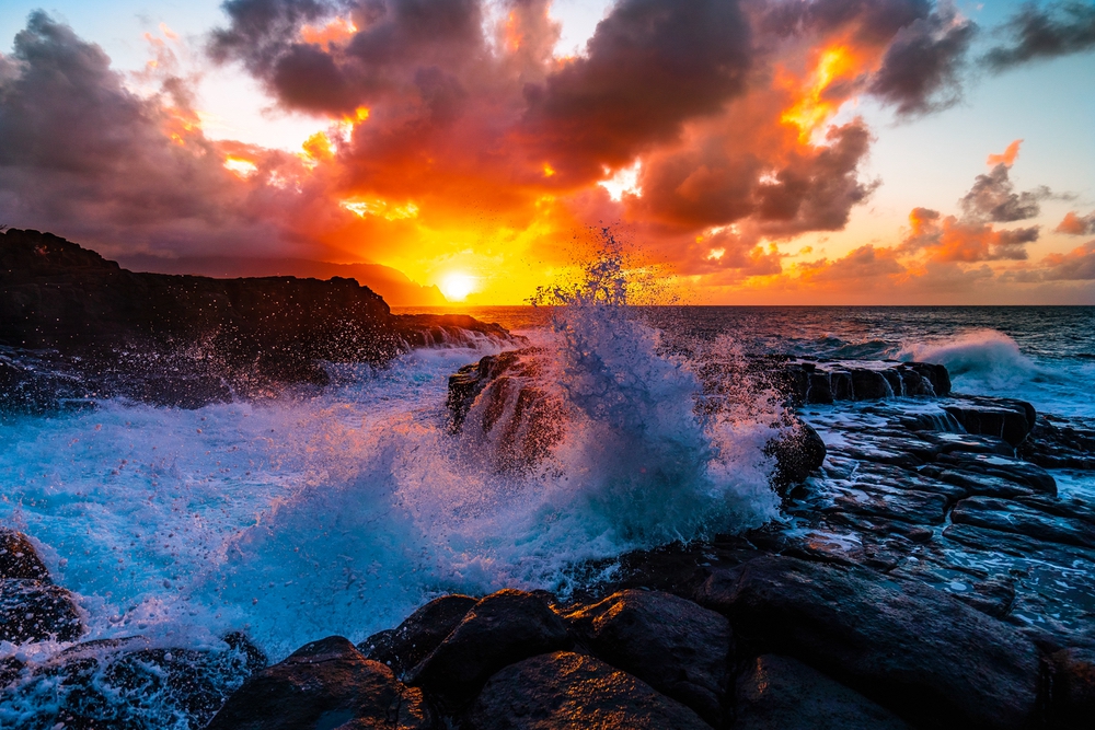 A beautiful scenery of rock formations by the sea at Queens Bath, Kauai, Hawaii at sunset