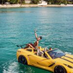Woman in yellow sports car boat on turquoise sea