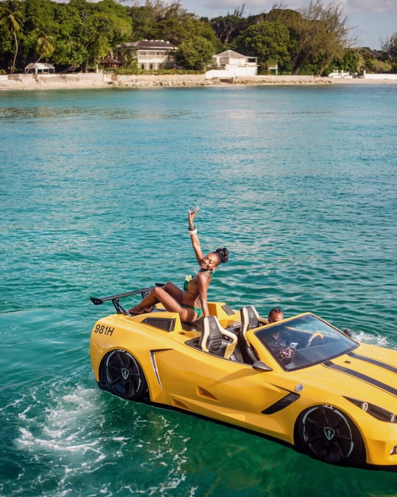 Woman in yellow sports car boat on turquoise sea