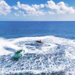 Speedboats creating waves in clear blue ocean