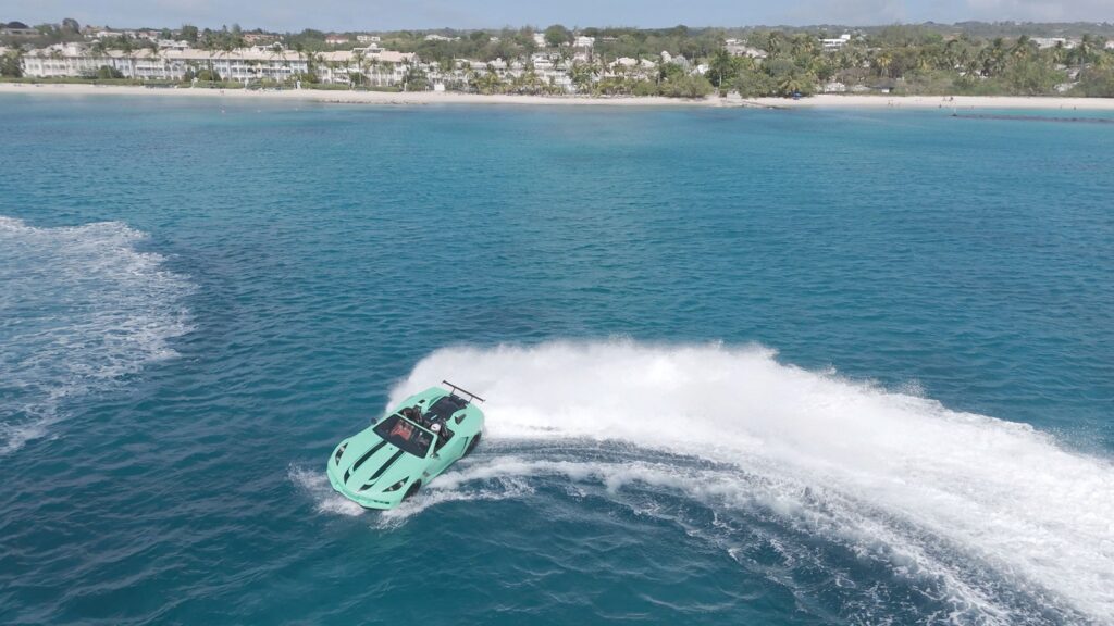 Speedboat creating waves near tropical beachfront