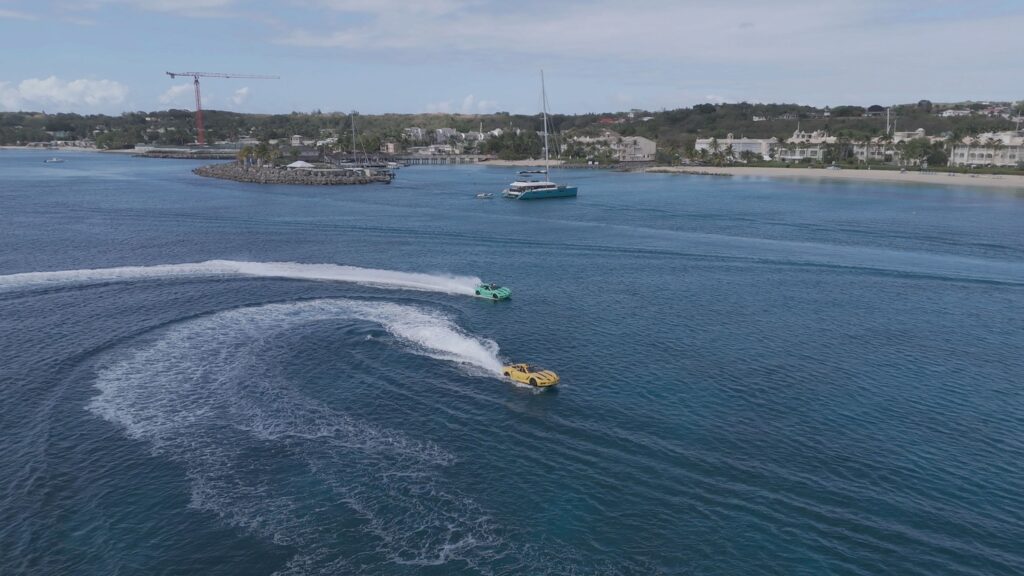 Speedboats creating wakes in scenic coastal harbor