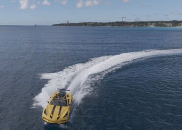 Yellow speedboat cruising on blue ocean