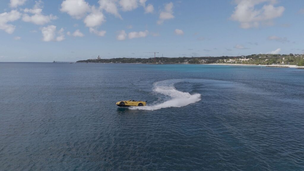 Yellow sports car floating on blue ocean water