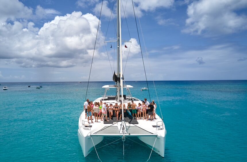 Group on yacht enjoying sunny tropical ocean
